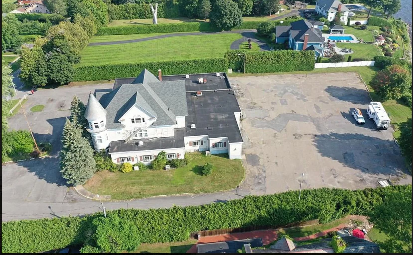 56 Cumberland Avenue from the air, showing the building, the lawn and the paved lot on its two-acre lot