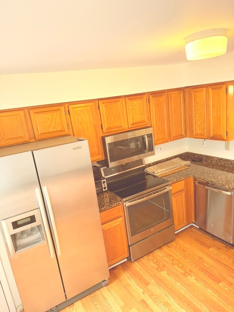 The kitchen, with oak cabinets, granite counters and stainless appliances